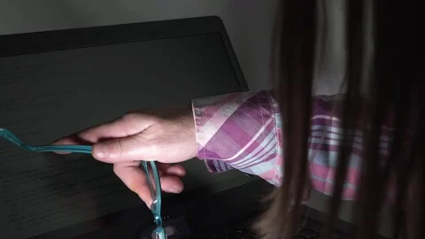 Woman with glasses pointing at computer code on a laptop close up shot 動画素材 145014079