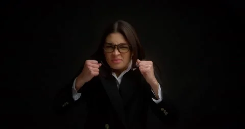 Woman with glasses, shouting with an aggressive expression and raised hands. Stock Footage 171560305