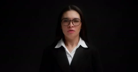 Woman with glasses, shouting with an aggressive expression and raised hands. Stock Footage 194098252