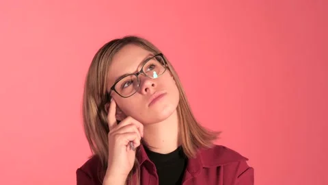 Woman In Glasses Thinking In Studio Setup Stock Footage 140534474