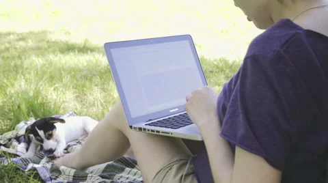 Woman in glasses using laptop computer in the park. Stock Footage 50542354
