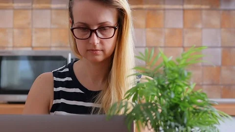 Woman in glasses using laptop computer Stock Footage 104270836
