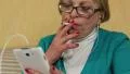 Woman in glasses with white smartphone smoking a cigarette HD Footage
