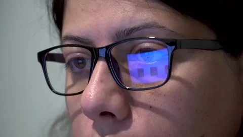 Woman with Glasses Working on Computer, Screen Reflection on Glass, Close Stock Footage 287704360
