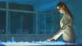 The woman in glasses working with a virtual screen on a hologram background 4k or 4k+ Resolution