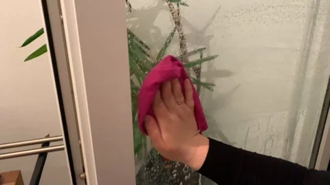 Woman in gloves washes a window Stock Footage 104763375