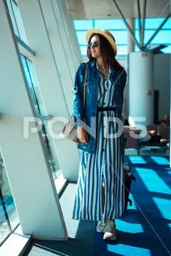 Woman go travel with suit case at airport Stock Photos
