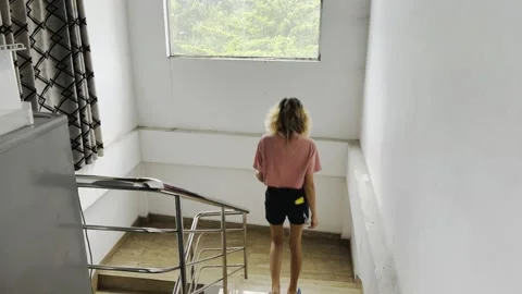 Woman going down stairs Stock Footage 232397751