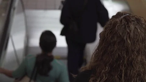 Woman going down an transit escalator Video stock 74861969