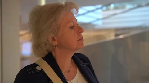 Woman going up in a glass elevator Stock Footage 249338723