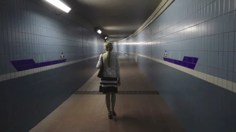 Woman is going in the underpass Stock Footage 61065539