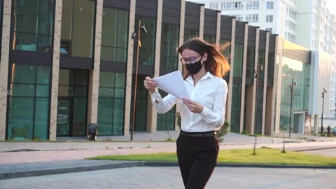 A Woman Going From Work With Papers Walking Near Office Building. Stock Footage 141079896
