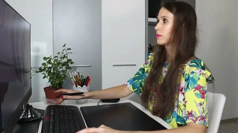 A woman, graphic designer, illustrator is using the graphic tablet Stock Footage 157304543