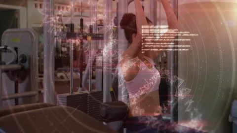 Woman grasping lat-pulldown bar, pulling for back strength in gym, DNA strands Stock Footage 330980370