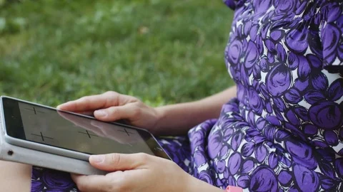 Woman on grass with tablet Stock Footage 77564192
