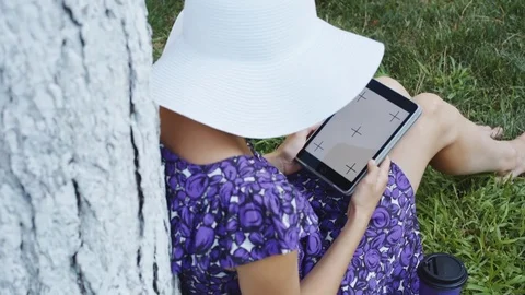 Woman on grass with tablet Stock Footage 77564686