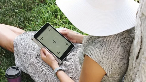 Woman on grass with tablet Stock Footage 77619140