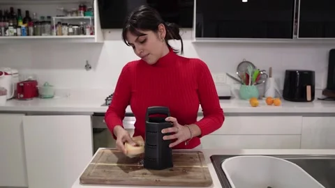 A woman grating cheese in the kitchen Stock Footage 279999064