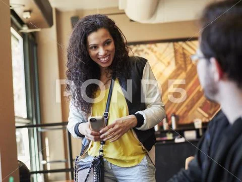 Woman Greeting Man In Cafe