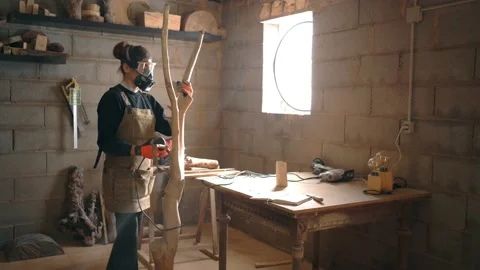 Woman grinding wood with sander in workshop Stock Footage 167421053