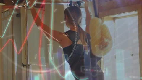 Woman gripping pullup bar, pulling up for fitness metrics with animated charts Stock Footage 330917305