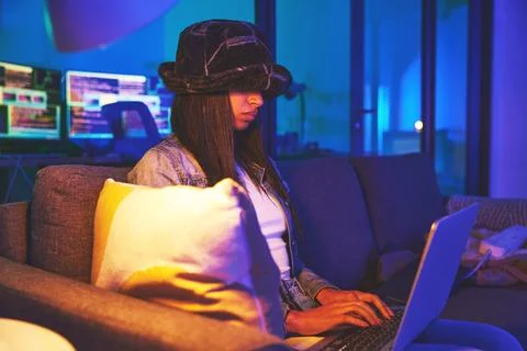 Woman, hacker and programmer typing on laptop in home at night in neon to hack Stock Photos