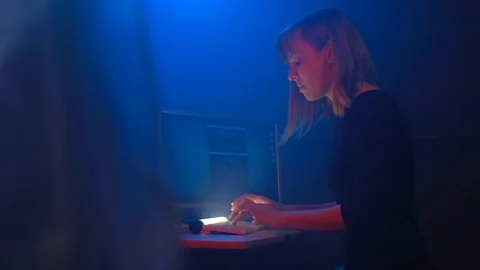 Woman hacker programmer is working on a computer in a dark office room. Video stock 90073579