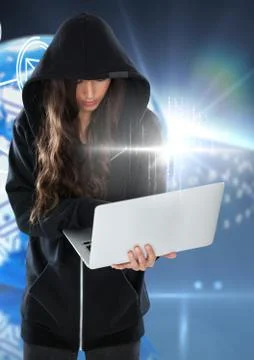 Woman hacker using a laptop in front of blue digital background 스톡 사진