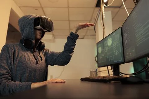 Woman hacking databse in metaverse, coding in vr glasses Stock-Fotos