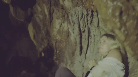 Woman hallucinating in cave Stock Footage 75505294