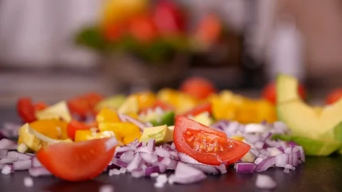 Woman hand adding salt to vegetables mix - slow motion Stock Footage 101633475