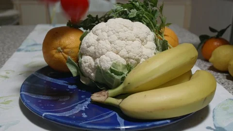 Woman hand arranges vegetables in a vegetable dish Stock Footage 124635381