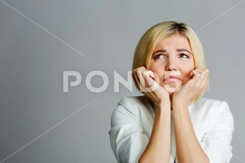 Woman with hand at chin Stock Photos