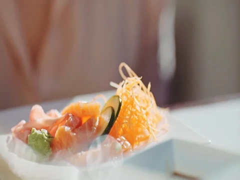 Woman Hand With Chopsticks Taking Salmon Sashimi. 4K Close Up. Stock Footage