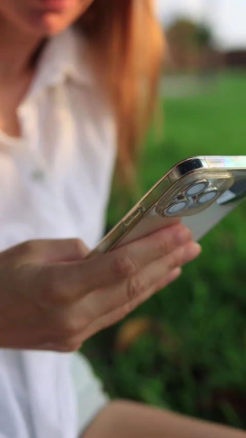 Woman hand close up using smartphone outdoors, showcasing montage of frames.. Stock Footage 285336782
