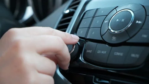 Woman hand control radio or music in car Stock Footage