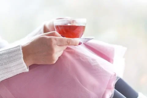 Woman hand cup of tea in window background Stock Photos