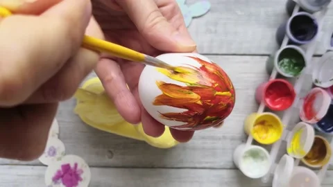 Woman hand drawing design on easter egg. Close-up Stock Footage 147357299
