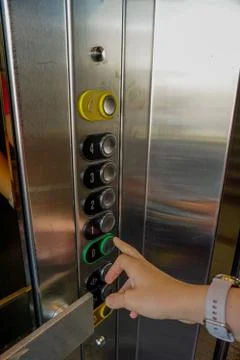 Woman hand on the elevator button close up view Foto stock
