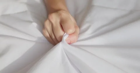 woman hand grasping sheets | Stock Video | Pond5