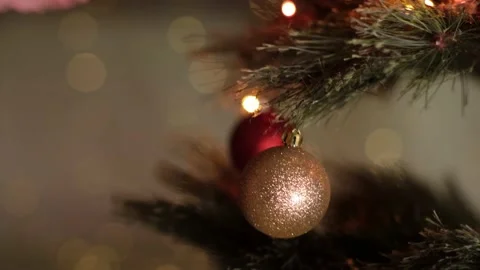 Woman hand hanging decorative gold ball on Christmas New Year tree branch Stock Footage 166317328