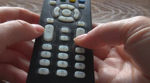 Woman hand hold remote control concept tv change channel letter bottom pattern  Stock Footage 39220904