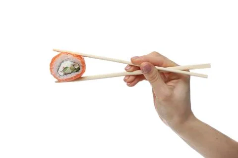 Woman hand holding fresh sushi roll with wooden chopsticks, isolated on white Stock Photos