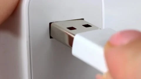 Woman hand inserting the usb cable into the white electric plug Stock Footage 223671235