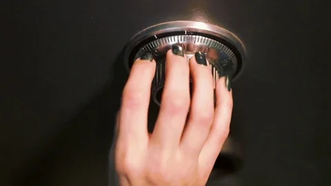 A Woman Hand Opens a Combination Lock on a steel vault Stock Footage 70397298