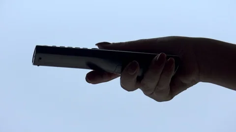 Woman hand operating a tv remote control Stock Footage 101818308