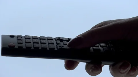 Woman hand operating a tv remote control Stock Footage 101818451