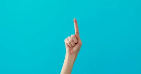 Woman hand points down by elegant finger on turquoise 動画素材 150625540