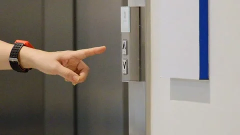 A woman hand  presses the elevator button on the panel to go up. Call and take t Stock Footage 156432153