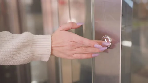 Woman hand pressing elevator button on steel panel Stock Footage 316821787
